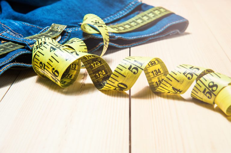 Jeans,And,A,Measuring,Tape.concept,Of,Loosing,Weight.