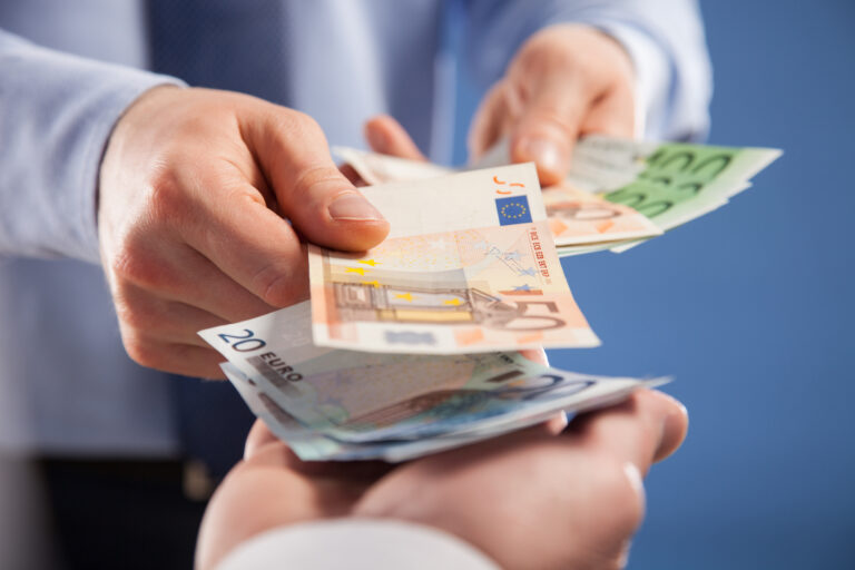 Businessman's,Hands,Exchanging,Euro,On,Blue,Background,,Closeup,Shot