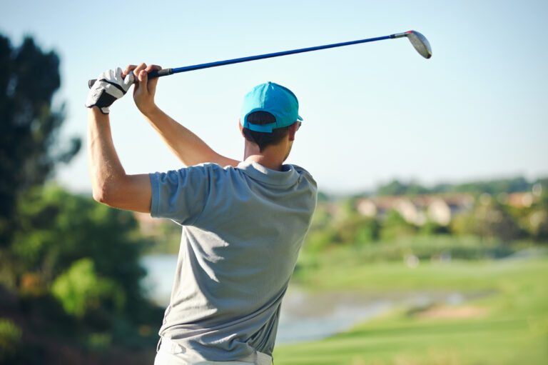 Golfer,Hitting,Golf,Shot,With,Club,On,Course,While,On