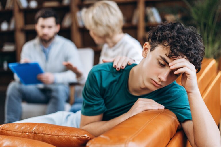 Portrait,Of,Upset,Stressed,Teenage,Boy,Waiting,Her,Mother,Talking